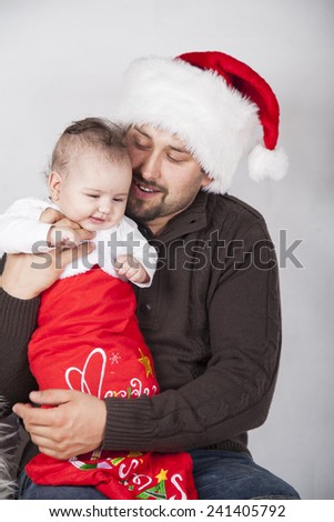 Happy dad with baby in festive clothes and Christmas interior,. Christmas, Holidays, New Year