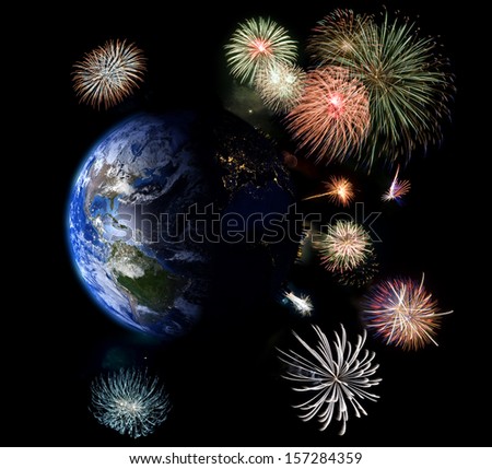 Global celebration. Fireworks surround the Earth. Street lights visible on the dark side of the planet. Elements of this image furnished by NASA. Isolated on black.