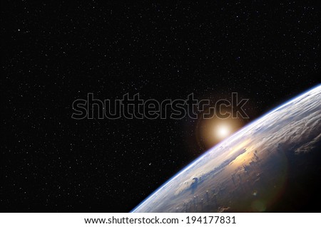 Sunrise over the Earth from space with stars in the background.  Elements of this image furnished by NASA.