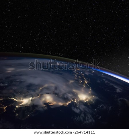 Japan at night from space with stars above. Elements of this image furnished by NASA.