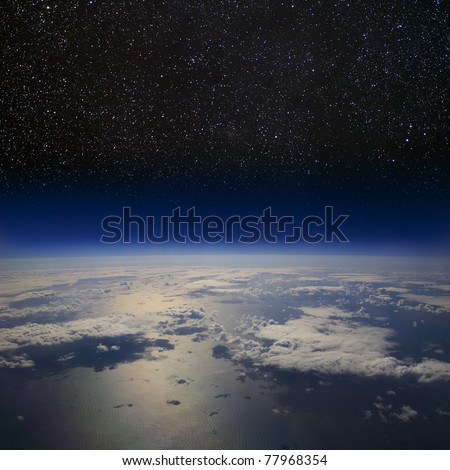The Earth in space. High altitude view of the surface against the starry night sky.