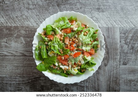 Chicken caesar salad on wooden table