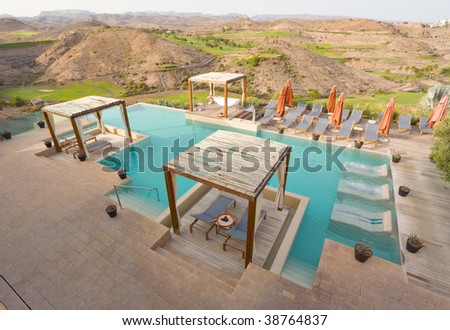 Luxury Pool Spa with Pergolas and view of a golf course