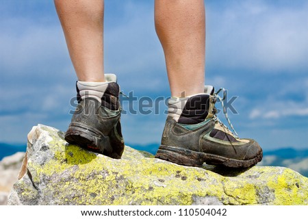 Hiking shoes closeup outdoors on the rock in the mountains