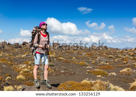 Woman hiking in the mountains, walking and backpacking