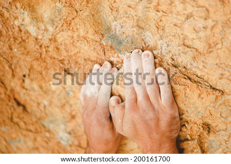 Rock climber\'s hands on handhold