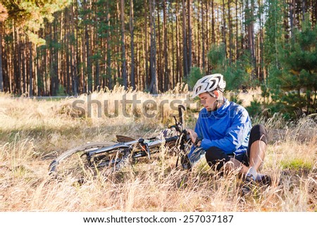 Cyclist with bicycle have a rest