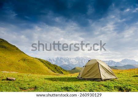 Tourist tent in camp among meadow in the mountain