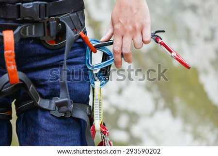 Extreme sport. quick-draws in climber\'s hand