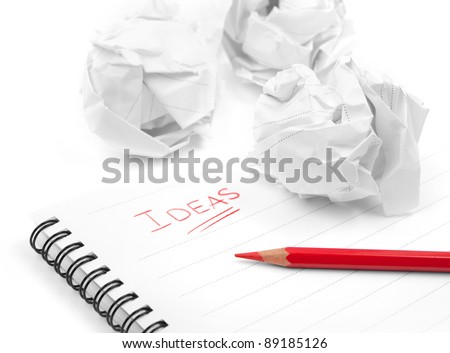 Creativity problems. Blank sheet of paper, red pencil, word Ideas and crumpled paper wads