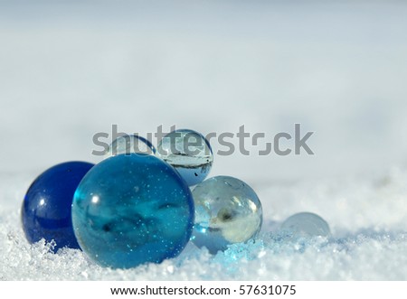 Blue and transparent balls on a snow in the winter