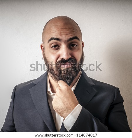 elegant bearded man with jacket and funny expressions on white background