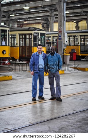 MILAN, ITALY - APRIL 19: Workers of magazine in Milan April 19, 2010. One time a year people can visit magazine garage of public transport company of Milan where there are old and new vehicles