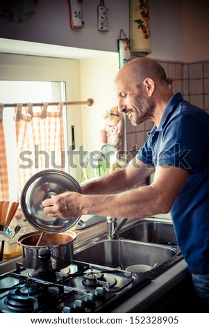 middle age man cooking  at home