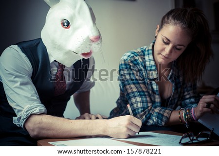 rabbit mask man and woman working at home