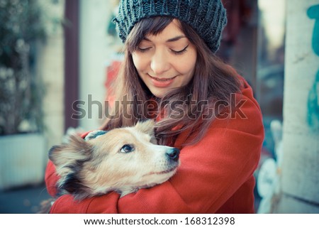 beautiful woman red coat winter hugging the dog