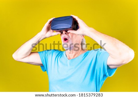 Astonished grandfather in VR goggles near children