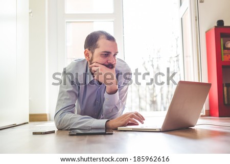 elegant business multitasking multimedia man using devices at home