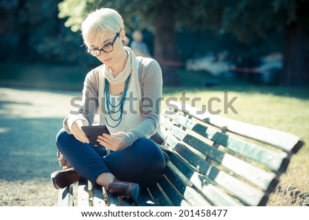 https://image.shutterstock.com/display_pic_with_logo/598642/201458477/stock-photo-beautiful-young-blonde-short-hair-hipster-woman-using-tablet-in-the-city-201458477.jpg