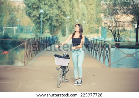 young beautiful brunette straight hair woman using bike outdoor