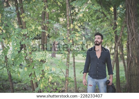young handsome attractive bearded model man in the woods