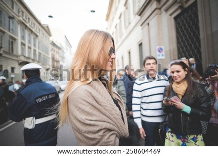 MILAN, ITALY - MARCH 01: People during Milan Fashion week, Italy on March, 01 2015. Eccentric and fashionable people outside city during Milan fashion week wait for models and famous people