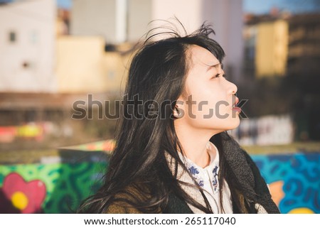 young beautiful asian hipster woman in the city
