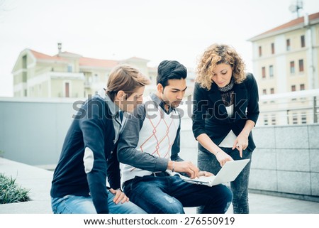 Multiracial business people working outdoor in town connected with technological devices