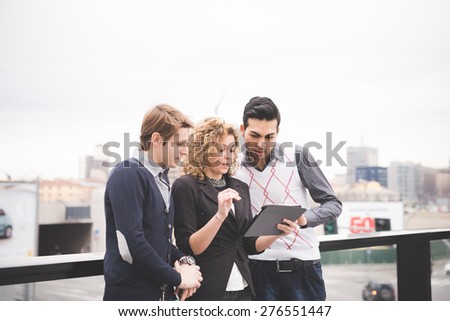 Multiracial business people working outdoor in town connected with technological devices