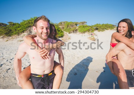 group of young multiethnic friend group of young multiethnic friends couple women and men at the beach in summertime having fun and smiling