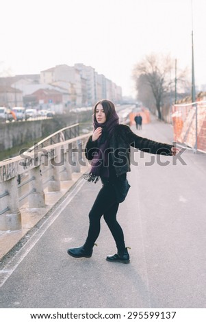 Young beautiful brunette caucasian girl dancing in the street. - freedom. dance concepts