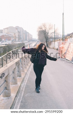 Young beautiful brunette caucasian girl dancing in the street. - freedom. dance concepts