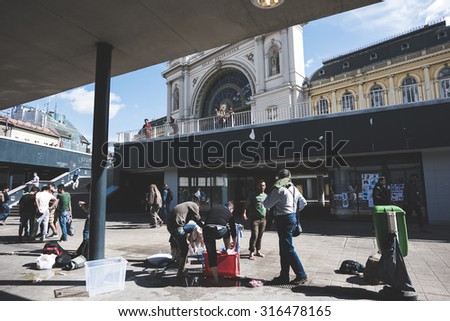 BUDAPEST - SEPTEMBER 7 : War syrian refugees at the Keleti Palyaudvar Railway Station on 1 September 2015 in Budapest, Hungary. Refugees washing themselves in a funtain outside the railway station.