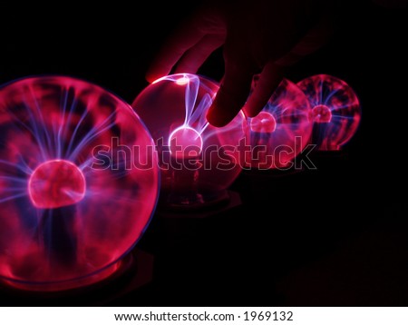 Multiple Plasma Globes, with Hand Touching One