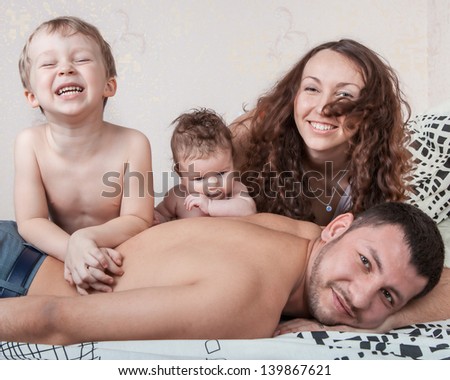 Happy family, mother, son and daughter, based on back his father