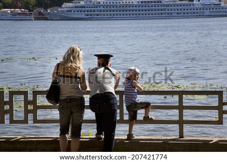 MOSCOW, RUSSIA - JULY 27: View of navy sailor family looking on a ship in Moscow 27 of July 2014. Russian celebrate Navy Day in Moscow