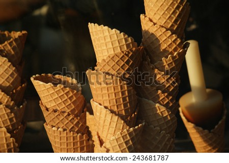Ice cream cones in the window of an ice cream shop.