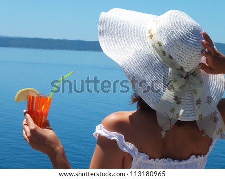 Beautiful woman drinking a cocktail by the sea/With a cocktail at Sea/Photography