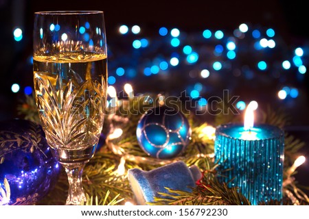 Champagne, ornaments and candles as a New Year decoration, New Year decorations, photography