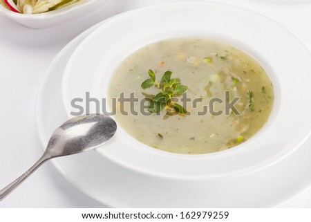Classic sweet corn soup. Garnished with mint. Served with salad and bread