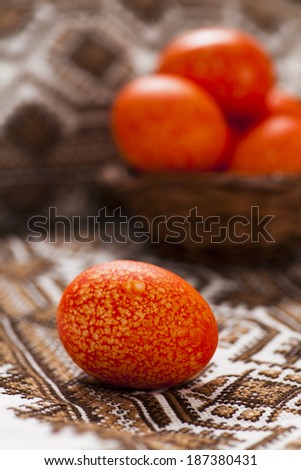 Orange Easter eggs on embroidered towel