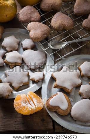 Decorating Gingerbread Christmas cookies with white icing and oranges