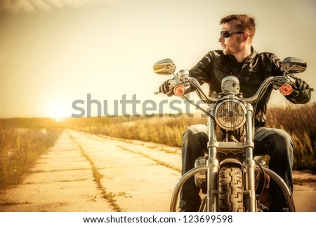 Biker man sits on a bike