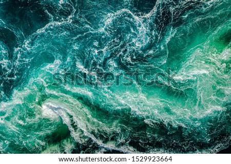 Waves of water of the river and the sea meet each other during high tide and low tide. Whirlpools of the maelstrom of Saltstraumen, Nordland, Norway Imagine de stoc © 