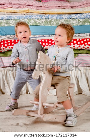Children play with a wooden Rocking Toy horse pony.