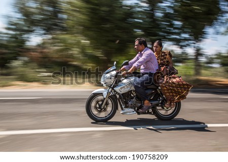 KERALA, INDIA - FEBRUARY 17: Family riding on a bike (blurred motion). Motorbike is the most favorite vehicle and most affordable for India.