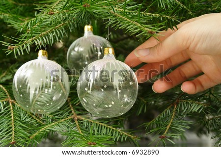 hanging glass ornament on natural christmas tree