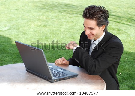 confident and successful young adult businessman sitting at an outdoor environment