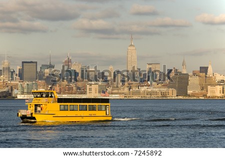 Liberty State Park Ferry on Hudson River with Mid-Town Manhattan in the background.