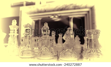 Classic Glass Chess Set in front of marble fireplace